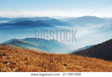 Spectacular View Of Hills Of A Smoky Mountain Range Covered In White Mist