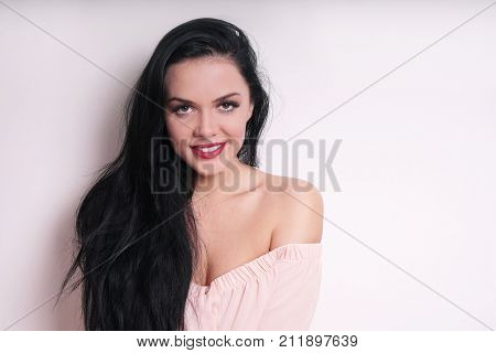 attractive young woman wearing off-the-shoulder blouse. with copy space.