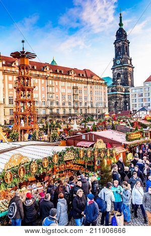 DRESDEN SAXONY / GERMANY - 17 DECEMBER 2016: People visit Christmas Market Striezelmarkt in Dresden Germany. Christmas fair European traditions.