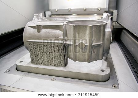 A model with supports created in a laser sintering machine stays in the working chamber. DMLS, SLM, SLS technology. Concept of 4.0 industrial revolution. Progressive modern additive technology.
