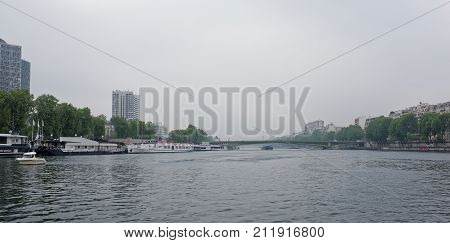 Paris; France-May 05; 2017: View of the Mirabeau Bridge. On the river Seine ships sail some moored in the port