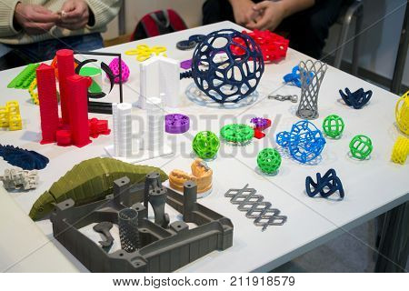 Objects printed on metal 3d printer and printer that prints plastic close-up. A model created in a laser sintering machine close-up. DMLS, SLM, SLS, FDM technology. Modern additive technology.