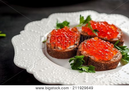 red caviar on black bread with butter. Healthy food. Fish appetizer.