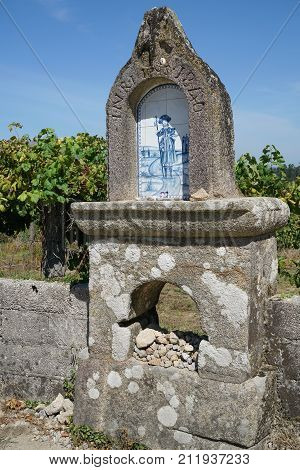 VITORINO DOS PIAES, PORTUGAL - SEPTEMBER 2, 2017: Waymark with relief of Saint James on the Camino de Santiago trail on September 2, 2017 in Portugal, Europe