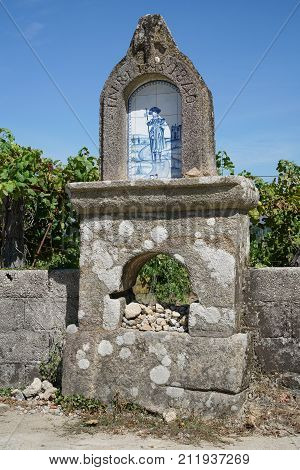 VITORINO DOS PIAES, PORTUGAL - SEPTEMBER 2, 2017: Waymark with relief of Saint James on the Camino de Santiago trail on September 2, 2017 in Portugal, Europe