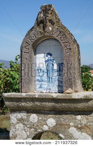 VITORINO DOS PIAES, PORTUGAL - SEPTEMBER 2, 2017: Waymark with relief of Saint James on the Camino de Santiago trail on September 2, 2017 in Portugal, Europe