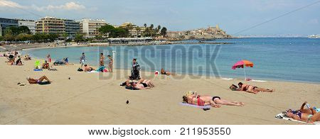 Antibes France - September 26 2017: People Sunbathing at Antibes Beach on a hot Autumn day.
