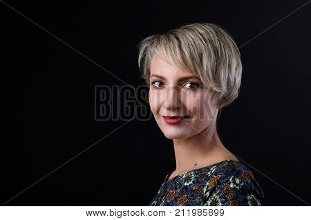 Portrait of successful caucasian blond Businesswoman on black background