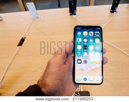 STRASBOURG FRANCE - NOV 3 2017: New Apple iPhone X smartphone goes on sale in Apple Store worldwide - man holding the iPhone with home screen