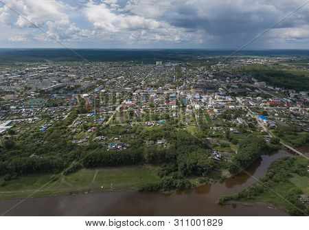 Irbit City And River. Russia. Aerial. Summer, Cloudy.  A Lots Of Trees And Grass