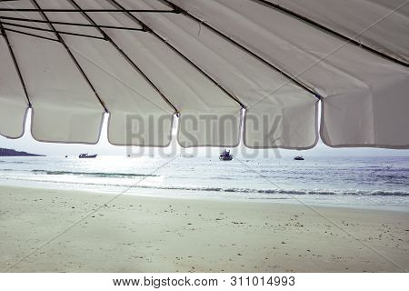 Landscape View Of Sea Beach In The Morning, Beach Umbellas And Bench On Seaside With Green Tree, Sum