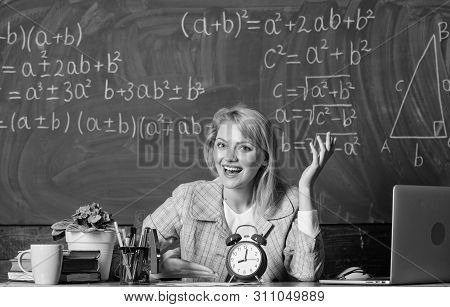 Teacher With Alarm Clock At Blackboard. Back To School. Teachers Day. Study And Education. Modern Sc
