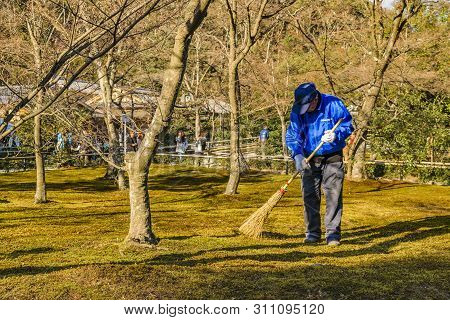 Kyoto, Japan, January - 2019 - Gardender Cleaning Surrounded Park At Famous Kinkakuji Zen Temple At 