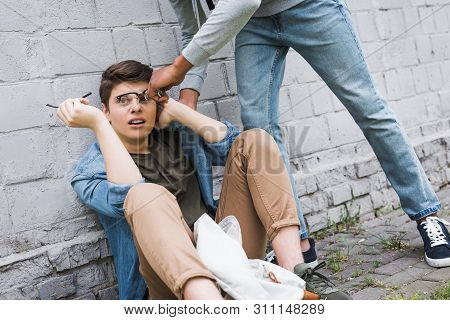 Aggressive And Brunette African American Boy Taking Off Glasses Of Frightened Boy