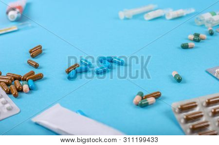 Close Up Of Medicine Pills On Blue Background.