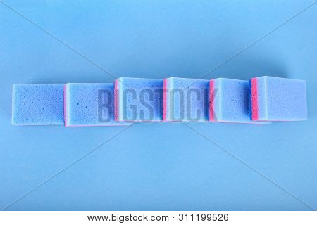 Cleaning Sponges On A Blue Background. With Copy Space For Text.