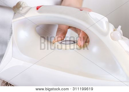 Hand Choosing Cycle Program On The Iron