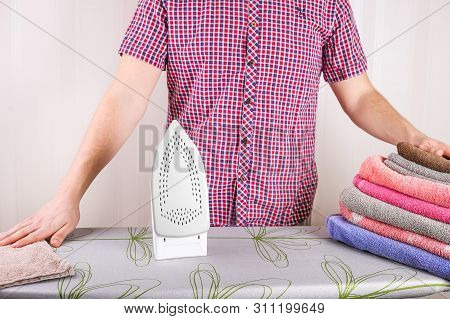 Man Ironing Shirt On Ironing Board. Steaming Iron. Clothes Ironing Board Household Concept