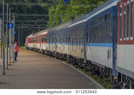 Night Train With Sleeping Coaches And Car And Motorcycle Coaches In Kysak Station In Summer Hot Morn
