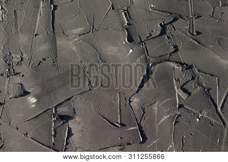Abstract Texture Background Of Black Color. Figured Plaster. Rough Cement Wall Closeup.