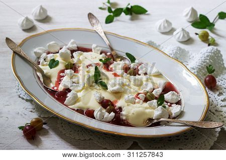 Eton Mess, Traditional English Dessert With Gooseberry, Whipped Cream And Meringue On A Light Backgr