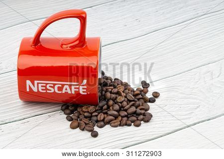 Kuala Lumpur, Malaysia - July 03, 2019: Promotional Red Nescafe Mug On Wooden Background. Selective 
