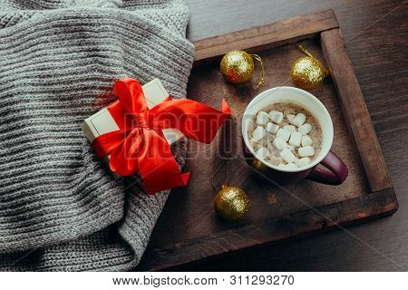 Top View Flat Lay Cozy Holidays Festive Crd Hot Chocolate ,gift Box And Sweater On A Wooden Tray