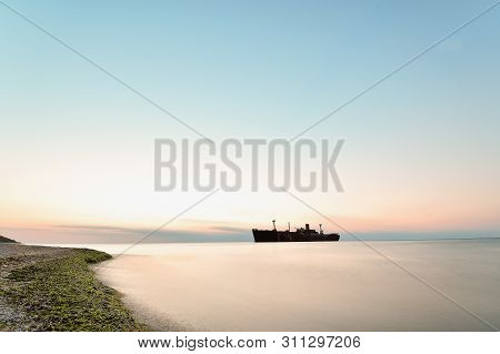 Beautiful Sunrise Seascape With A Ship Wreck On The Shore Of Black Sea Near Costinesti, Long Expose