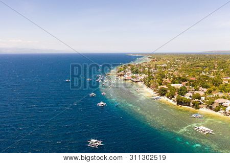Coast Of Cebu Island, Moalboal, Philippines, Top View. Philippine Boats In A Blue Lagoon Over Coral 