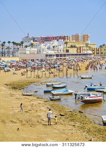 Cadiz, Spain - June 23, 2019. People Enjoying A Sunbathing In La Caleta Beach. View From Duque De Na