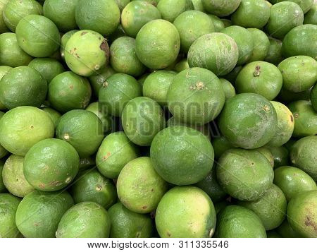 Green Lemons Selling In The Market Background