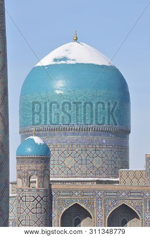 The Blue Domes Of Shokhi Zinda Are Covered With Snow. The Ensemble Is A Sunny Winter Day.