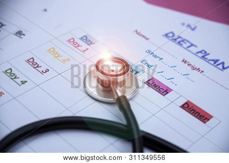 The Blurry Light Adesign Background Of  Stethoscope Put Beside Diet Schedule Plan,