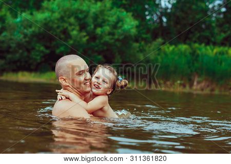 Happy Family Father And Son. Dad Teaches His Son To Swim