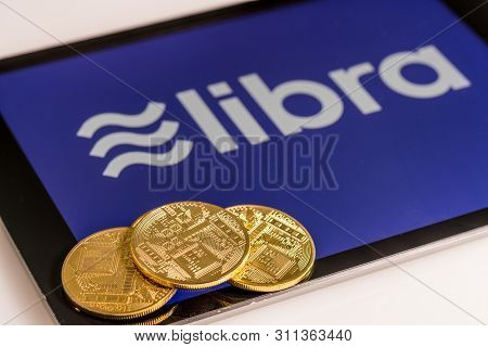 Morgantown, Wv - 14 July 2019: Golden Cybercurrency Coins On Top Of Tablet Computer As Concept For F