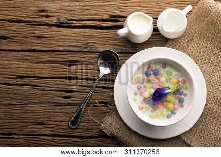 Thai Sweets And Colorful Ball Flour In A White Cup On A Sackcloth, Coconut On An Old Wooden Table Ra