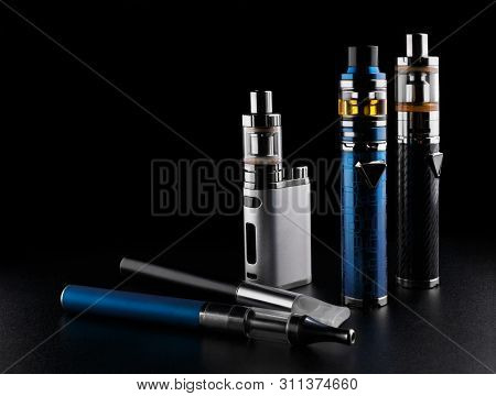Electronic Cigarettes Or Vaping Devices On Black Background