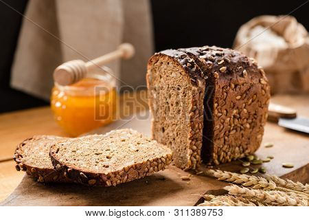 Loaf Of Rye Bread With Sunflower Seeds In A Bakery. Rustic Still Life
