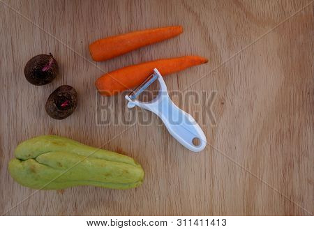 Beets, Carrots And Chayote With Peeler On Wood Table.