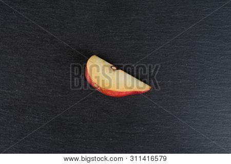 One Slice Of Fresh Dark Red Pear Anjou Flatlay On Grey Stone