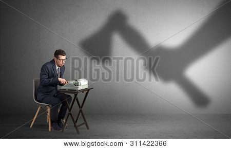 Shadow threatening hard worker man who is afraid