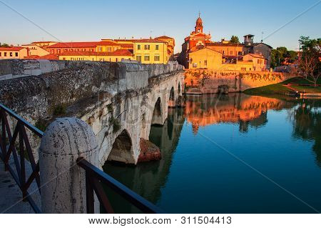 Rimini Cityscape At Sunset, Italy. Rimini Landmarks. Tiberius Bridge In Rimini In The Evening, Italy
