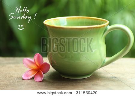 Hello Sunday Greetings, With Green Natural Ceramic Cup Of Healthy Tea Or Coffee And Pink Bali Frangi