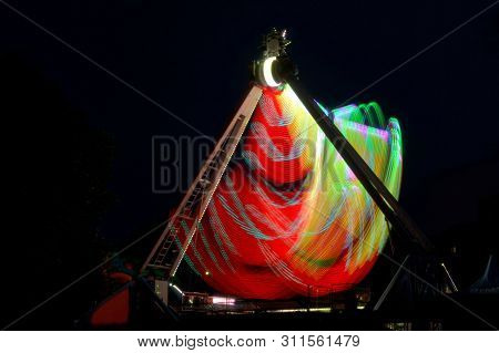 Extreme Attraction In Lunapark, With Multi-colored Red And Yellow Lights, Long Exposure Shooting In 