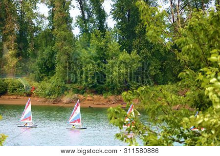 June 28, 2019 In Portland, Or:  People In A Sail Club And Dinghy Sailing Which Is Sailing On Miniatu