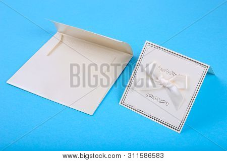 Empty Card In Blue Envelope On Blue Background. Holiday And Invitation Mockup.
