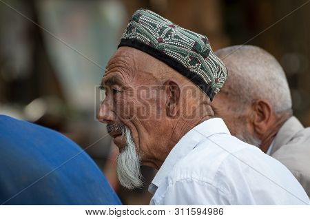 Kashgar, Xinjiang, China - August 14, 2012: Portrait Of A Uyghur Man At A Street Market In The City 
