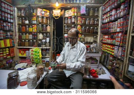 VARANASI, INDIA - MAR 22, 2018: Seller on one of the streets of the old city near holy Ganges river. According to legends, the city was founded by God Shiva about 5000 years ago.