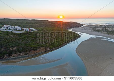 Aerial from Amoreira beach on the westcoast in Portugal at sunset