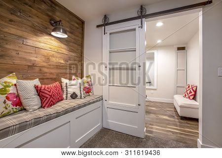 Built In Banquette Along The Brown Wood Wall Of A Home With Carpeted Floor